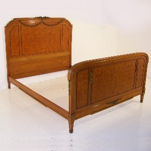 An Antique French Bed With Mahogany Marquetry Inlaid Panels